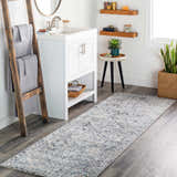 Bathroom scene with white vanity, ladder with towels, and Balamban Area Rug runner in brick red, cream, denim, and gray. Roomscene-Runner