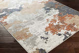 Close-up of the Balerno Area Rug showing the charcoal, blue, gray, mustard, terracotta, and white contemporary design. Corner