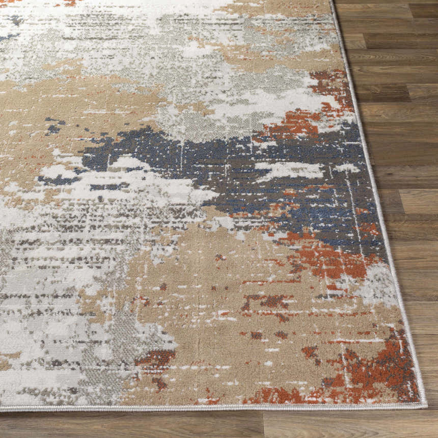 Close-up of the Balerno Area Rug showing its contemporary charcoal, blue, terracotta, and gray abstract design. Front