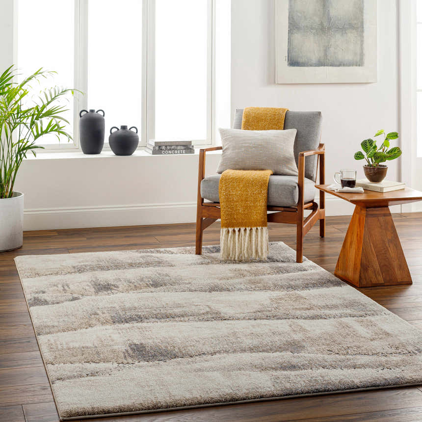 Living room with Banji Abstract Waves Area Rug, gray chair, wood side table, and natural light. Roomscene-Rectangle