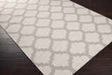 Close-up of the Banks Ivory/Gray Trellis Wool Rug showing the trellis pattern and wool texture on dark wood floors. Corner