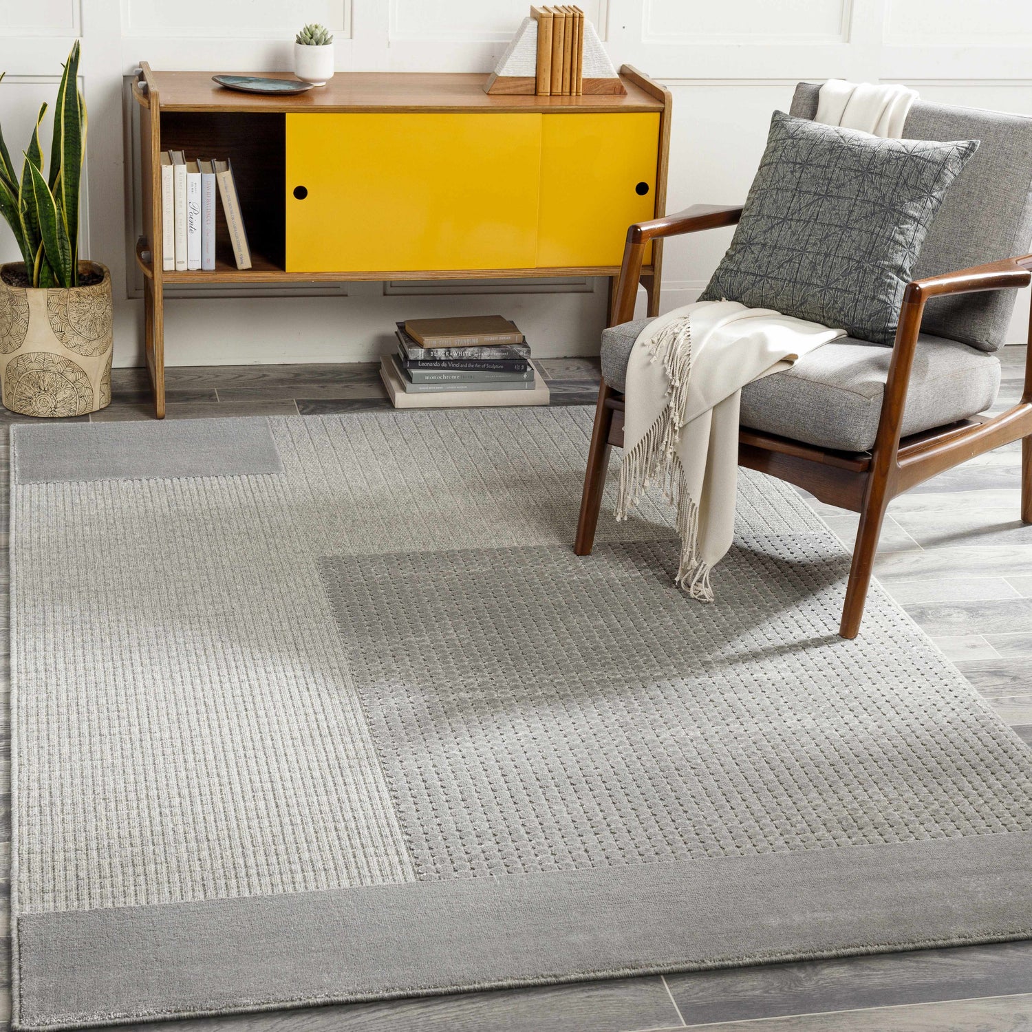 Mid-century modern living room with gray Bantiqui Area Rug, yellow cabinet, and gray chair. Scandinavian style. Roomscene-Rectangle