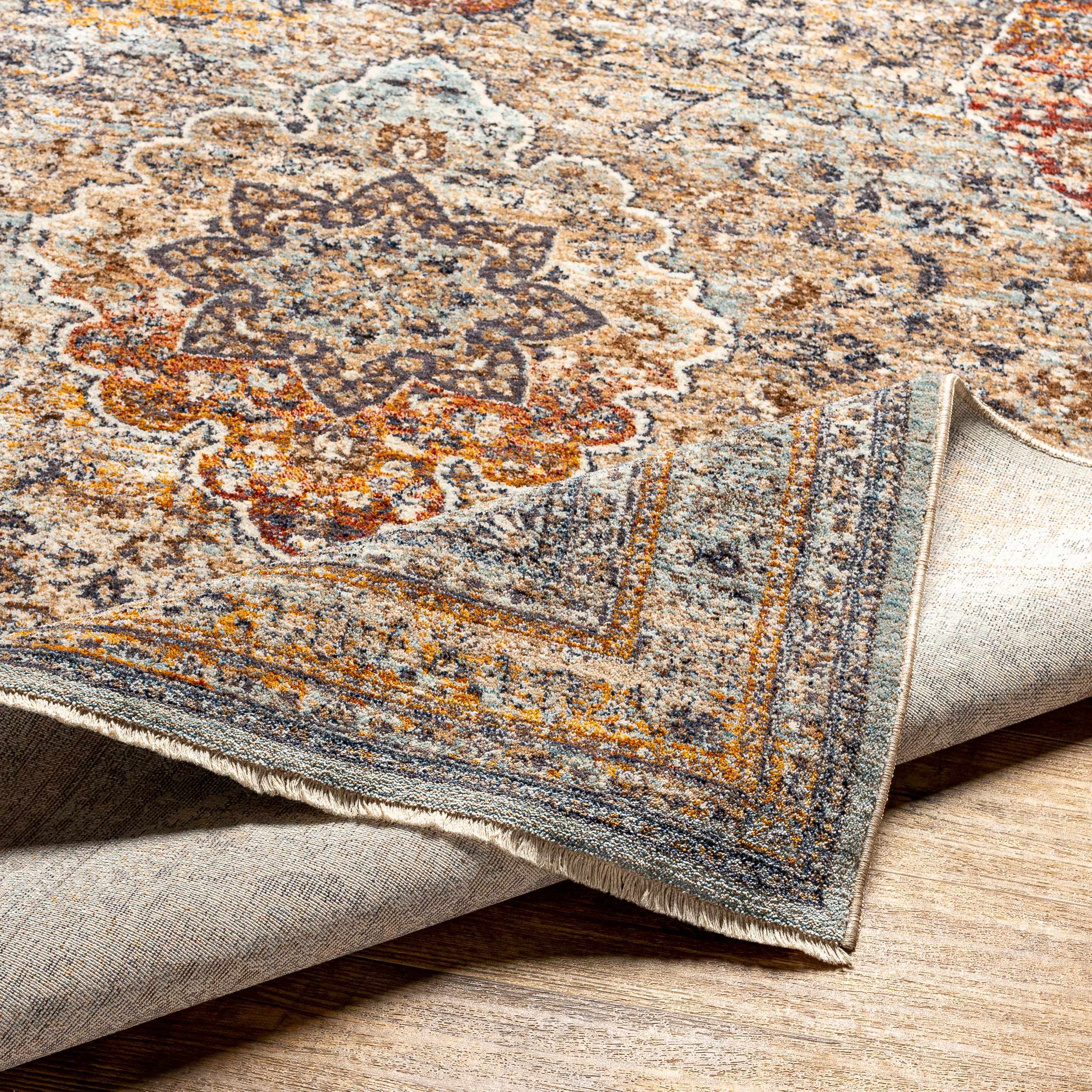 Folded section of Baon Area Rug - Clearance, displaying material thickness and weave. Traditional Area Rug Backing  