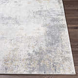 Close-up of the Baranduda Abstract Gray Luxe Rug showing charcoal, beige, and gray abstract pattern. Front