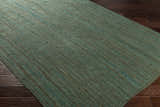 Close-up of the Barksdale Green Hand Woven Jute rug showing its charcoal, mint colors, and natural fiber texture. Corner