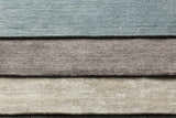 Close-up of Barree Area Carpet showing its white, gray, and blue hues and soft, hand-loomed viscose texture. Styleshot