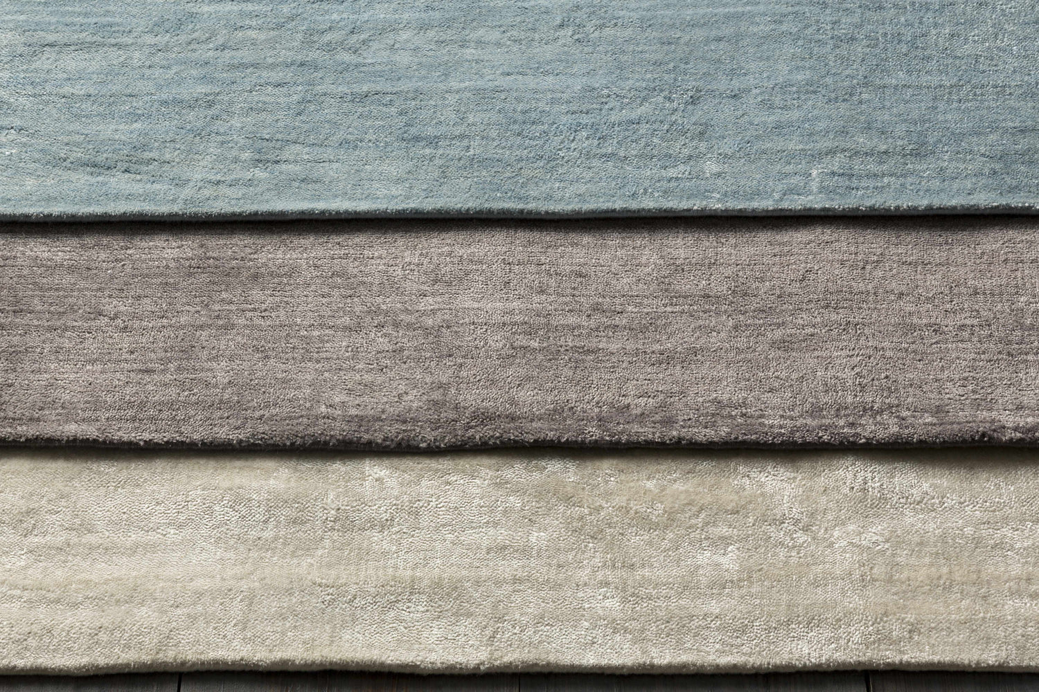 Close-up of Barree Area Carpet showing its white, gray, and blue hues and soft, hand-loomed viscose texture. Styleshot