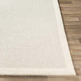 Close-up of the Barrow Wool Rug. Cream rug features a subtle striped pattern and a plush texture. Front