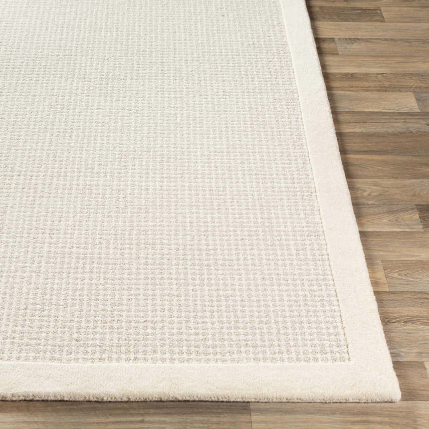Close-up of the Barrow Wool Rug. Cream rug features a subtle striped pattern and a plush texture. Front