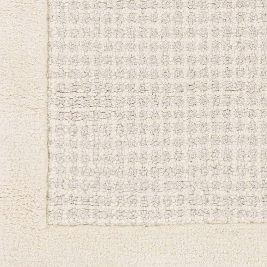 Close-up of the Barrow Wool Rug. Cream border and light gray textured pattern. Hand-tufted wool rug. Swatch
