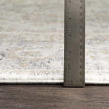 Close-up of Beebe Luxe rug showing pile height with ruler. Colors: ivory, gray, and brown. Machine woven texture. Pile