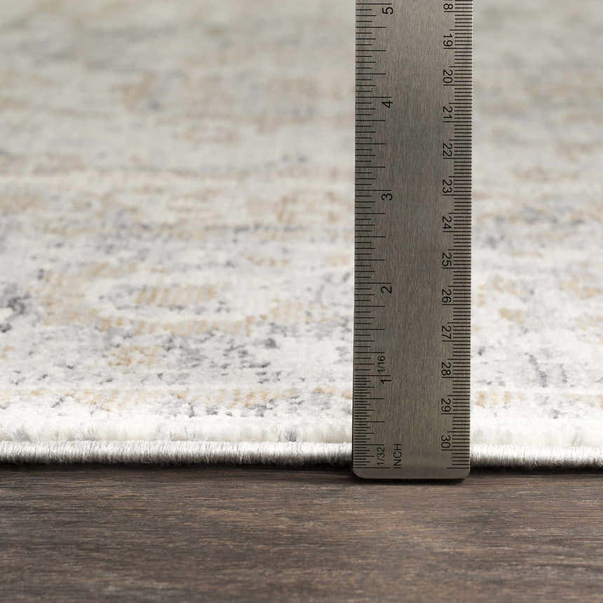 Close-up of Beebe Luxe rug showing pile height with ruler. Colors: ivory, gray, and brown. Machine woven texture. Pile