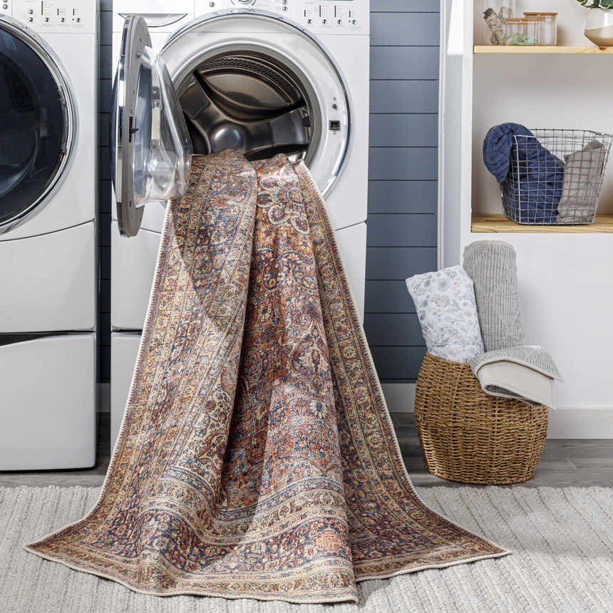 Laundry room scene with Belison Washable Area Rug coming out of a washing machine, showing its traditional pattern. Washing-Machine