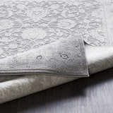 Close-up of the Benavides Gray Updated Traditional Tibetan Rug showing floral patterns and texture. Fold