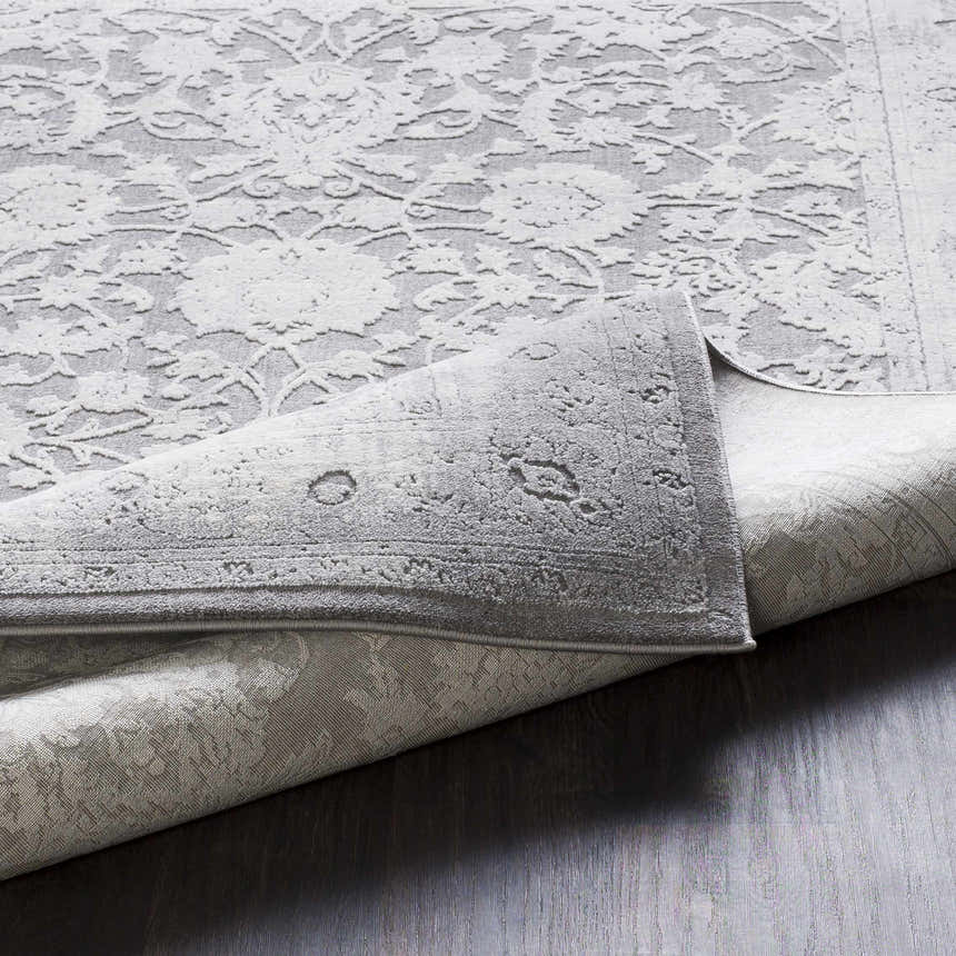Close-up of the Benavides Gray Updated Traditional Tibetan Rug showing floral patterns and texture. Fold