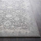 Close-up of the Benavides Gray Updated Traditional Tibetan Rug showing floral pattern and charcoal, gray, and ivory colors. Front