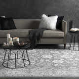 Living room scene with gray sofa, candles, and the Benavides Gray Updated Traditional Tibetan Rug. Roomscene-Rectangle