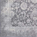 Close-up of the Benavides Gray Updated Traditional Tibetan Rug featuring a floral pattern and distressed border. Swatch
