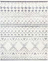 Close-up of the Benezett Area Rug, a white shag rug with a gray bohemian-inspired geometric pattern. Design-Rectangle-710103