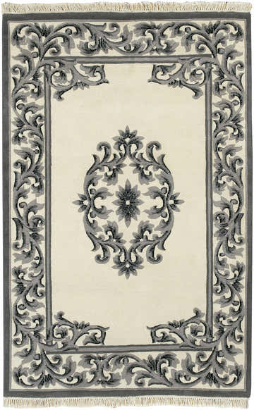 Close-up of the hand-knotted Bengal Black Area Rug. Features a gray floral pattern on a cream background with fringe. Design-Rectangle-5383