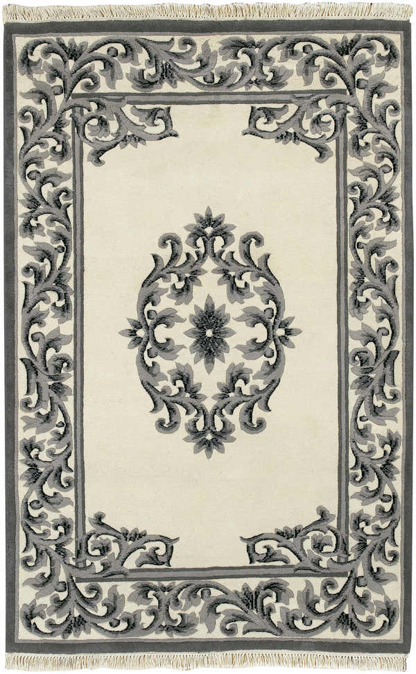 Close-up of the hand-knotted Bengal Black Area Rug. Features a gray floral pattern on a cream background with fringe. Design-Rectangle-5383