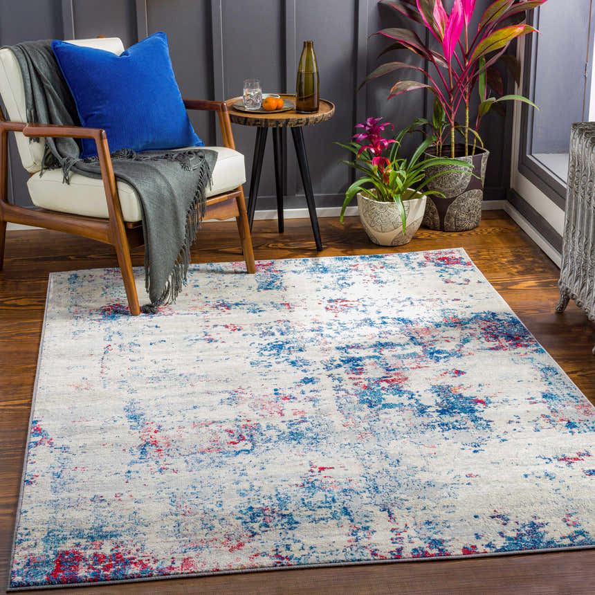 Living room scene with a Bergvliet Area Rug in blue, burgundy, and cream under a modern chair and side table. Roomscene-Rectangle