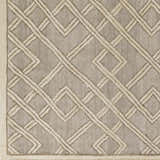 Close-up of Bevier Area Rug. Dusty sage rug with a light gray geometric trellis pattern and hand woven texture. Swatch