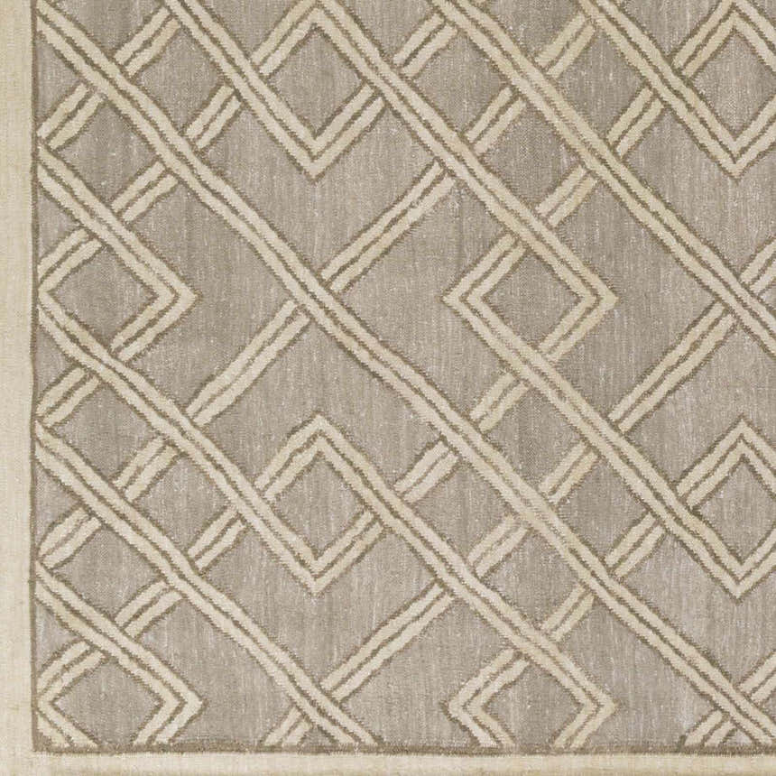 Close-up of Bevier Area Rug. Dusty sage rug with a light gray geometric trellis pattern and hand woven texture. Swatch
