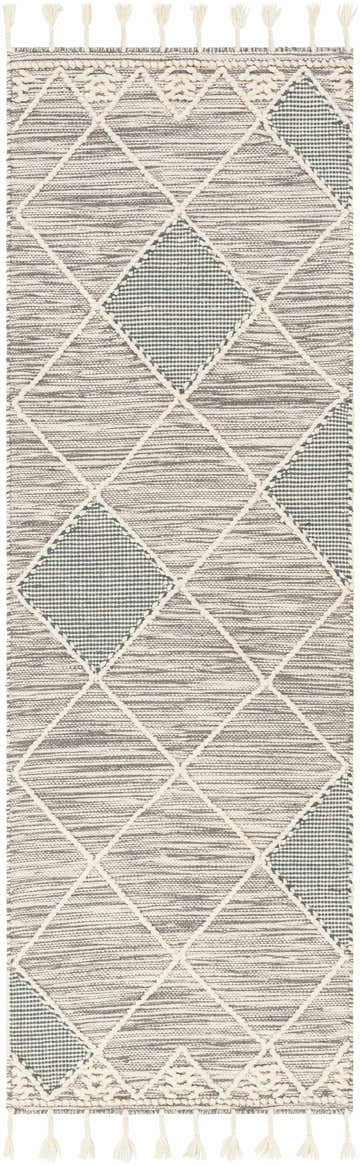 Close-up of the Bicos Tasseled Jute Rug. Hand-woven wool rug with a geometric diamond pattern in charcoal, cream, and gray. Design-Runner-268