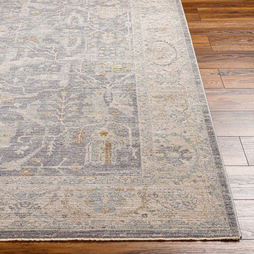 Close-up of Binx Thick Luxe Statement Rug showing traditional pattern, brown, charcoal, sage and gray colors on wood floor. Front