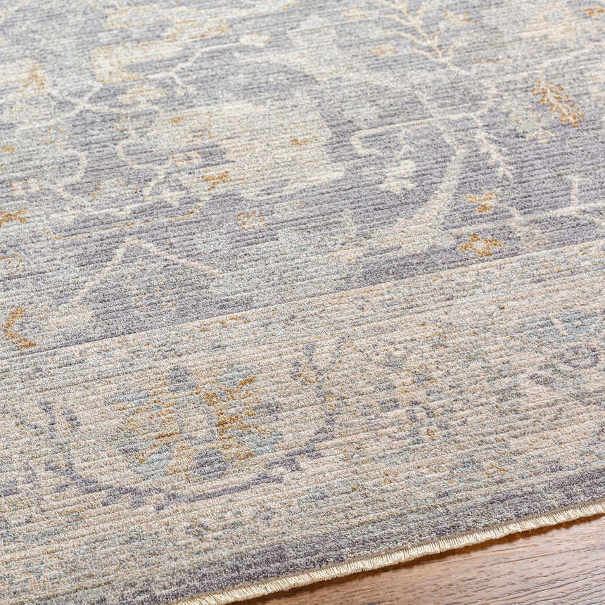Close-up of the Binx Thick Luxe Statement Rug showing its traditional pattern in brown, charcoal, and gray tones. Texture
