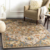 Living room scene with a Birtley Area Rug in bohemian style, featuring blue, rust, and camel colors. Roomscene-Rectangle
