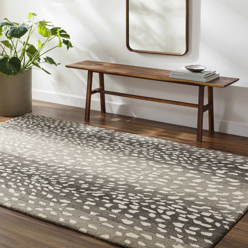 Entryway with beige walls, wood floors, and Athena Giraffe Print Wool Rug. Bench, mirror, and potted plant complete the scene. Roomscene-Rectangle