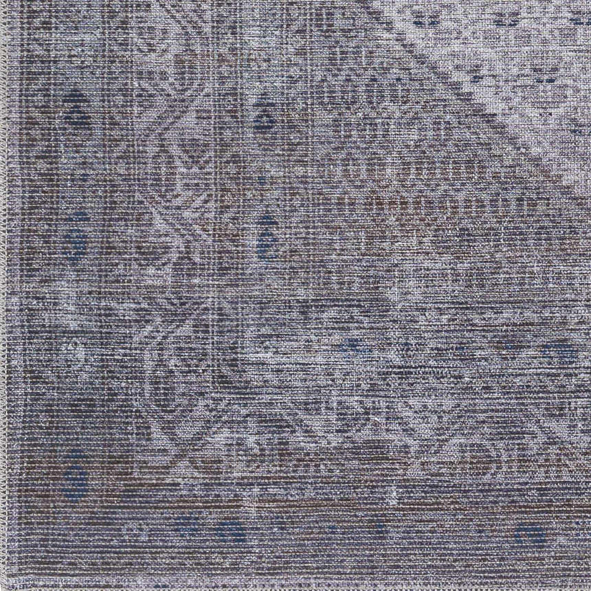 Close-up of the Brown Ballinasloe Vintage Washable Area Rug, featuring a traditional pattern in dark brown, light gray, and navy. Swatch