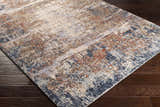Close-up of Bonaventure Area Rug on dark wood floor. Charcoal, red, gray, navy, and rust contemporary design. Corner