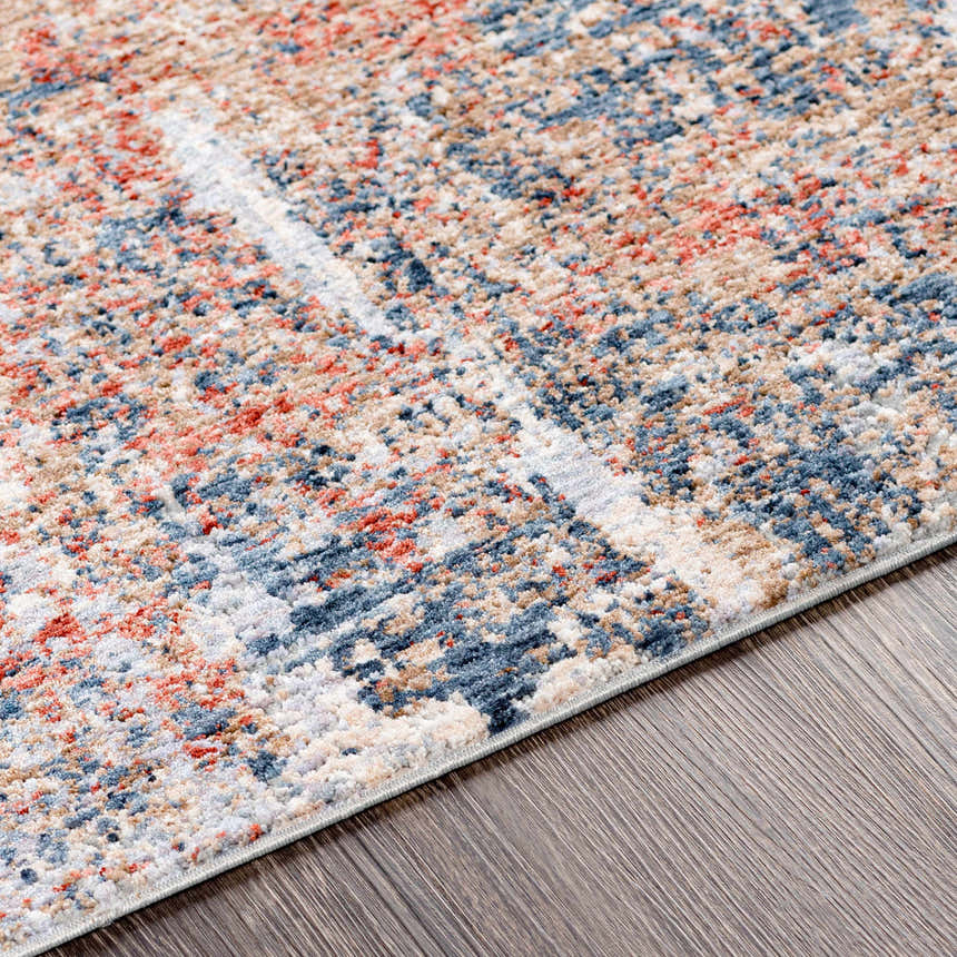 Close-up of the Bonaventure Area Rug showing charcoal, dark red, light gray, and navy hues with a contemporary pattern. Texture