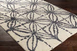 Close-up of Bonnyman Jute Carpet. Hand-woven rug with black floral pattern on ivory. Contemporary style. Corner