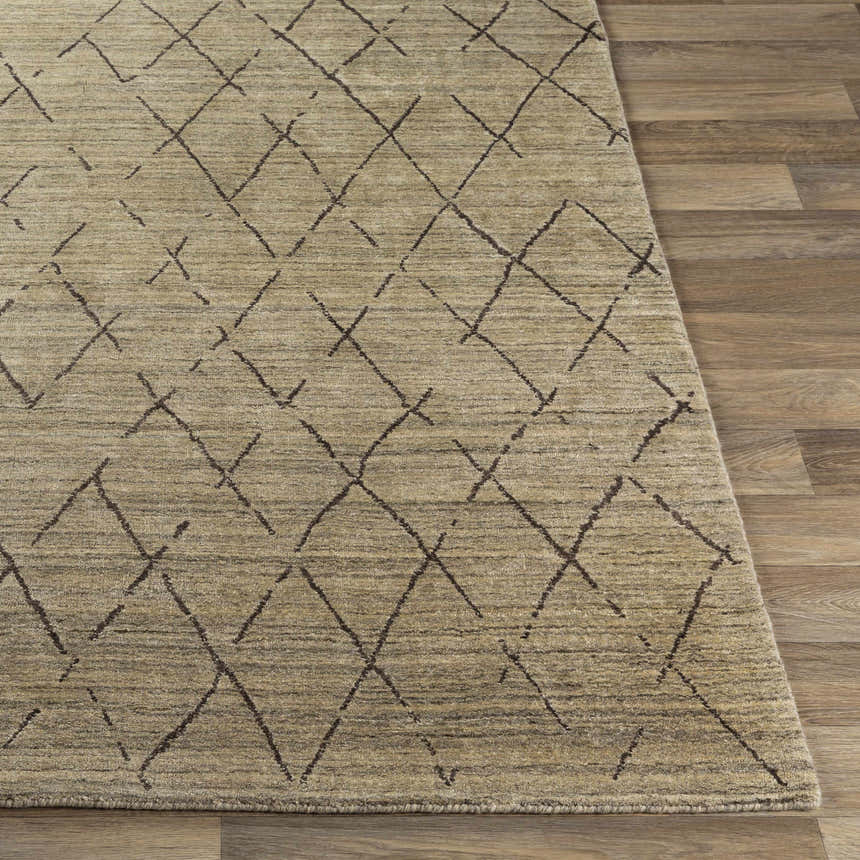 Close-up of the Bonogin Area Rug showing its tan color and dark brown geometric diamond pattern on wood floors. Front