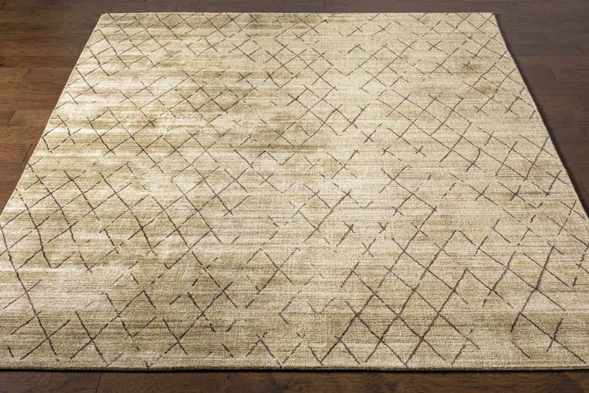 Close-up of the Bonogin Area Rug showing its olive and tan colors and dark brown geometric diamond pattern. Front