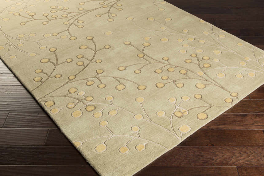 Close-up of the Olive Elsu Area Rug showing its olive, tan, and mustard floral design and hand-tufted wool texture. Corner