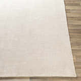 Close-up of the hand-loomed Bowstring Carpet. Cream and taupe viscose rug with a subtle, contemporary texture. Front