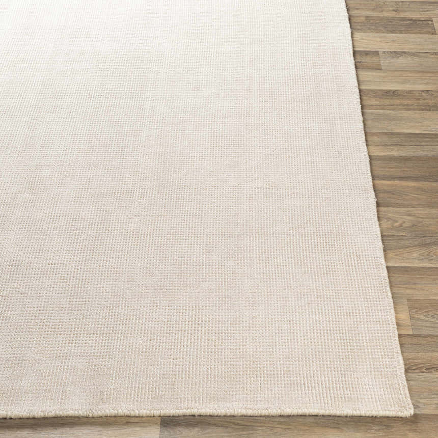 Close-up of the hand-loomed Bowstring Carpet. Cream and taupe viscose rug with a subtle, contemporary texture. Front