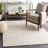 Living room scene with a cream Bowstring Carpet, gray armchair, and a modern console table. Roomscene-Rectangle