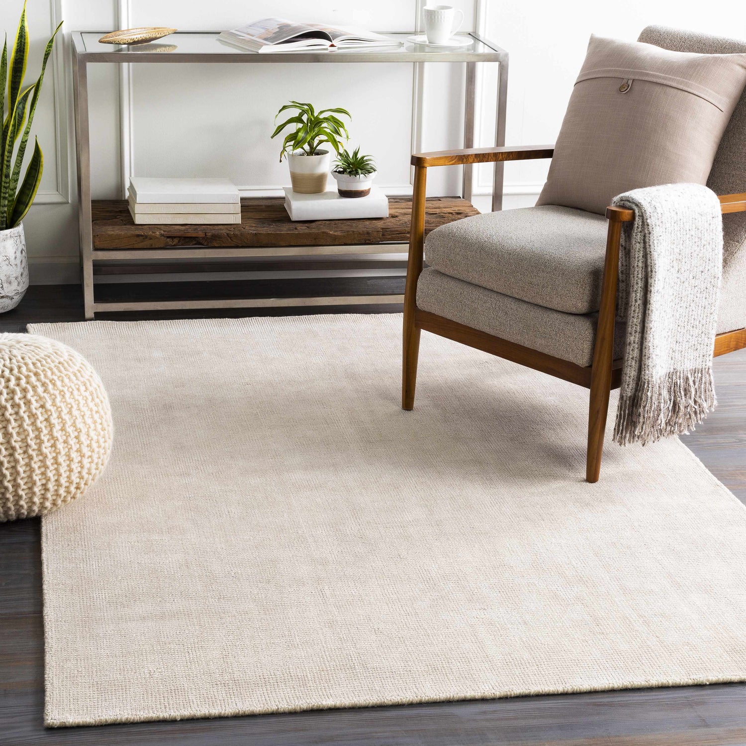 Living room scene with a cream Bowstring Carpet, gray armchair, and a modern console table. Roomscene-Rectangle