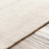 Close-up of the hand-loomed Bowstring Carpet. Cream and taupe viscose rug with a subtle, contemporary texture. Texture