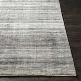 Braxton Carved Statement Area Rug in gray, ivory, and sage on a dark wood floor. Contemporary style. Front