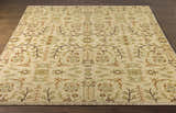 Close-up of the hand-knotted Brentford Carpet. Features a traditional floral and branch pattern in oatmeal, olive, brown, and tan. Front