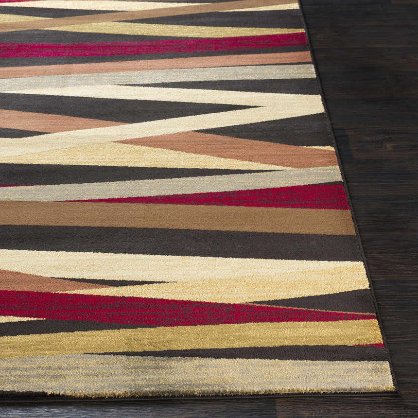 Close-up of the Brevard Striped Area Rug showing beige, brown, red, and gray stripes on dark wood floors. Front