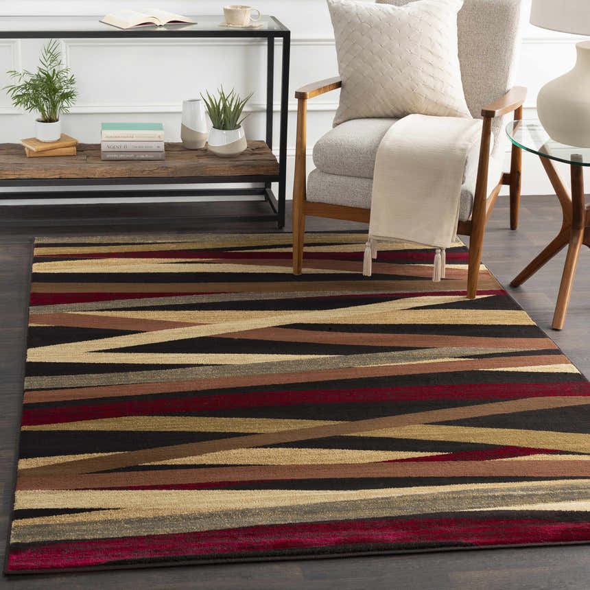 Living room scene with Brevard Striped Area Rug. Contemporary style with beige chair, wood accents, and striped rug in brown, red, and beige. Roomscene-Rectangle