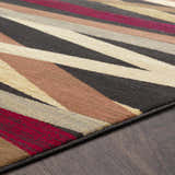 Close-up of Brevard Striped Area Rug showing beige, brown, red, and gray stripes on a dark wood floor. Contemporary style. Texture